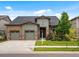Charming home with a two-car garage, complemented by lush landscaping and a warm, inviting exterior at 2113 Fountain Cir, Erie, CO 80516