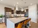 Stunning kitchen features stainless steel appliances, a large island with seating, and pendant lighting at 2113 Fountain Cir, Erie, CO 80516