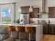 Gorgeous kitchen island with pendant lights and seating overlooks the living area for easy entertaining at 2113 Fountain Cir, Erie, CO 80516
