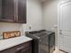 Well-equipped laundry room featuring modern washer, dryer, and countertop space at 2113 Fountain Cir, Erie, CO 80516