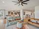 Open-concept living room showcasing modern furniture, hardwood floors, and a seamless flow to the kitchen at 2113 Fountain Cir, Erie, CO 80516