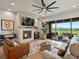 A cozy living room featuring a stone fireplace, modern fan, and a great view of the outdoor patio at 2113 Fountain Cir, Erie, CO 80516