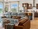 Inviting living space seamlessly connects to the modern kitchen, bathed in natural light and offering scenic views at 2113 Fountain Cir, Erie, CO 80516