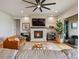 Comfortable living room showcasing a fireplace, large screen TV, and access to an outdoor patio at 2113 Fountain Cir, Erie, CO 80516