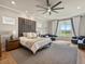Relaxing main bedroom featuring a decorative headboard, sitting area, and large windows at 2113 Fountain Cir, Erie, CO 80516