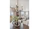 Stylish dining area showcasing a modern chandelier, large windows and a view into the living area at 4206 Sandstone Dr, Mead, CO 80504