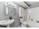 This bathroom features gray walls, white shower, and a white pedestal sink at 13626 E Bates Ave # 110, Aurora, CO 80014
