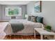 Comfortable bedroom featuring a window, white bedding, and natural light at 13626 E Bates Ave # 110, Aurora, CO 80014