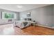 Bright bedroom featuring a large window, white bedding, and natural light at 13626 E Bates Ave # 110, Aurora, CO 80014