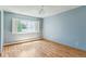 Comfortable bedroom featuring hardwood floors, a large window, and neutral paint at 13626 E Bates Ave # 110, Aurora, CO 80014