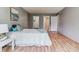 This bedroom features light hardwood floors, gray walls, and a closet with a bathroom just off the room at 13626 E Bates Ave # 110, Aurora, CO 80014