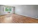 Sunny bedroom features hardwood floors and bright window with decorative valance at 13626 E Bates Ave # 110, Aurora, CO 80014