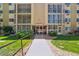 Exterior view of the building's front entrance with landscaped walkway at 13626 E Bates Ave # 110, Aurora, CO 80014