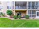 Exterior building view featuring well maintained lawn, bushes and patio for each unit at 13626 E Bates Ave # 110, Aurora, CO 80014