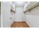 Walk-in closet with shelving and hardwood floors providing practical storage space at 13626 E Bates Ave # 110, Aurora, CO 80014
