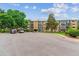 Well-maintained exterior of a condo complex, surrounded by mature trees and landscaping at 13626 E Bates Ave # 110, Aurora, CO 80014