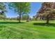 Scenic view of the golf course with lush green grass and mature trees at 13626 E Bates Ave # 110, Aurora, CO 80014