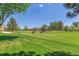 Expansive golf course with well-maintained greens and players with golf carts at 13626 E Bates Ave # 110, Aurora, CO 80014