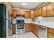Classic kitchen design featuring wood cabinets, stainless steel appliances, and light countertops at 13626 E Bates Ave # 110, Aurora, CO 80014