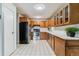 Bright kitchen featuring wood cabinets, stainless steel appliances, and light countertops at 13626 E Bates Ave # 110, Aurora, CO 80014