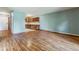 Bright living room featuring wood floors and an adjacent kitchen at 13626 E Bates Ave # 110, Aurora, CO 80014