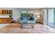 Living room featuring a comfortable gray sofa, wood floors, and a modern coffee table at 13626 E Bates Ave # 110, Aurora, CO 80014
