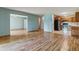 Spacious living room featuring hardwood floors that lead into an open kitchen with updated appliances at 13626 E Bates Ave # 110, Aurora, CO 80014