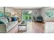 Bright living room with gray sofa, modern coffee table, and sliding glass doors to the outside at 13626 E Bates Ave # 110, Aurora, CO 80014