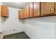 Bright storage room with wooden cabinets and neutral-toned carpet, offering ample space and functionality at 13626 E Bates Ave # 110, Aurora, CO 80014