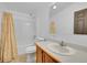 Bathroom with shower-tub combo, single sink, and wood cabinet at 6631 E 78Th Avenue Ave, Commerce City, CO 80022