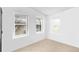 A neutral-toned bedroom features three windows and carpet at 6631 E 78Th Avenue Ave, Commerce City, CO 80022