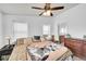 Well-lit bedroom with ceiling fan, dresser, and neutral walls at 6631 E 78Th Avenue Ave, Commerce City, CO 80022