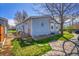 Exterior view of home with a side porch and a driveway and mature landscaping at 6631 E 78Th Avenue Ave, Commerce City, CO 80022