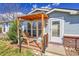 Inviting front porch with seating area, a decorative door, and well maintained landscaping at 6631 E 78Th Avenue Ave, Commerce City, CO 80022