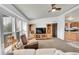 Living room featuring neutral carpeting, large windows, and seamless flow to the kitchen at 6631 E 78Th Avenue Ave, Commerce City, CO 80022