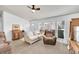 Bright living room features neutral carpeting, a large window, and comfortable seating at 6631 E 78Th Avenue Ave, Commerce City, CO 80022