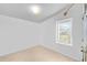 A clean and simple room with a window and neutral carpet at 6631 E 78Th Avenue Ave, Commerce City, CO 80022