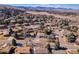 A scenic aerial view shows the property nestled among trees, with mountains visible in the background at 13577 W Alaska Dr, Lakewood, CO 80228