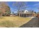 View of the backyard showing patio, grass, fence, and surrounding trees at 13577 W Alaska Dr, Lakewood, CO 80228