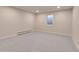 This basement is carpeted with neutral walls, recessed lighting and a window at 13577 W Alaska Dr, Lakewood, CO 80228
