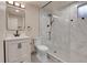 Bathroom features a marble tiled glass shower, toilet, and sink with a black framed mirror at 13577 W Alaska Dr, Lakewood, CO 80228