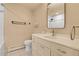 Cozy bathroom with a single vanity, tiled floors, and shower with tile surround at 13577 W Alaska Dr, Lakewood, CO 80228