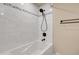 Bathroom featuring a jetted tub with shower, tile surround, and modern fixtures at 13577 W Alaska Dr, Lakewood, CO 80228