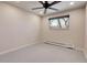 Clean, carpeted bedroom featuring a window, heater, and ceiling fan at 13577 W Alaska Dr, Lakewood, CO 80228