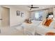 Open bedroom with plush carpet, balcony access, ceiling fan, and natural light at 13577 W Alaska Dr, Lakewood, CO 80228