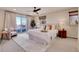 Spacious bedroom featuring a king bed, plush carpet, balcony access, and bright natural light at 13577 W Alaska Dr, Lakewood, CO 80228