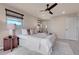 Bright bedroom with plush carpet, ceiling fan, neutral walls, and natural light at 13577 W Alaska Dr, Lakewood, CO 80228