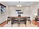 Open concept dining room with modern chandelier, area rug and hardwood floors at 13577 W Alaska Dr, Lakewood, CO 80228
