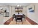Open concept dining room with modern chandelier and stainless appliances in adjacent kitchen at 13577 W Alaska Dr, Lakewood, CO 80228