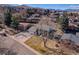 Beautiful exterior elevation of home with columns and a well-maintained yard against a mountain backdrop at 13577 W Alaska Dr, Lakewood, CO 80228